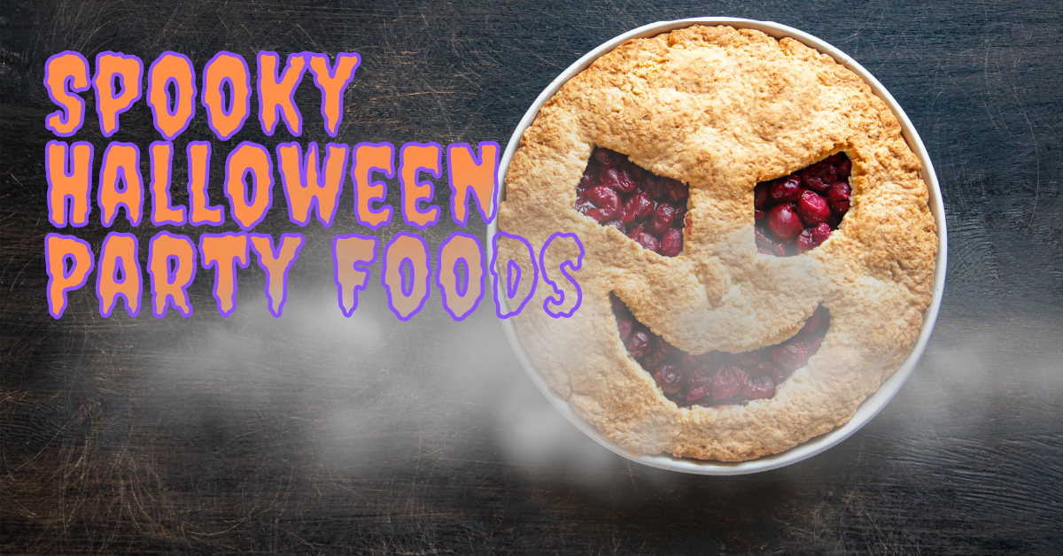 A cherry pie that looks like a scary face sits behind eery fog. On the left side of the image is a orange and purple text that reads "Spooky Halloween Party Foods"