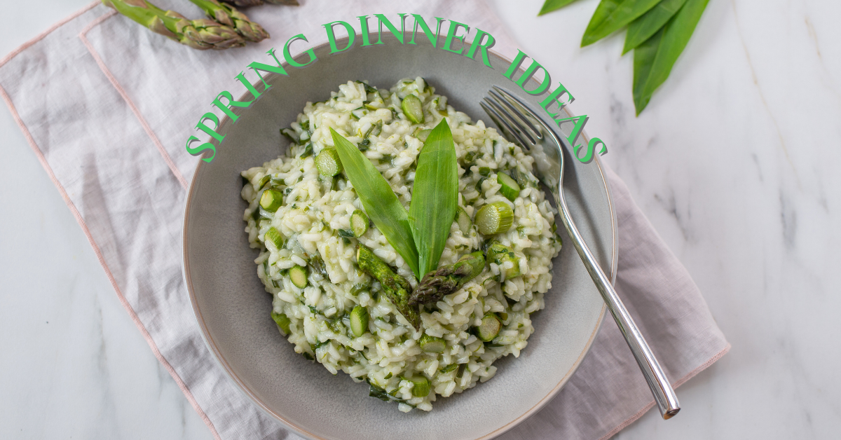 Spring Dinner Setting with Asparagus sitting in the top left corner, greenery in the top right corner, and a bowl of risotto and green vegetables taking up the rest of the image. the text "spring dinner ideas" is in green in a semi circular shape around the edge of the bowl of the risotto