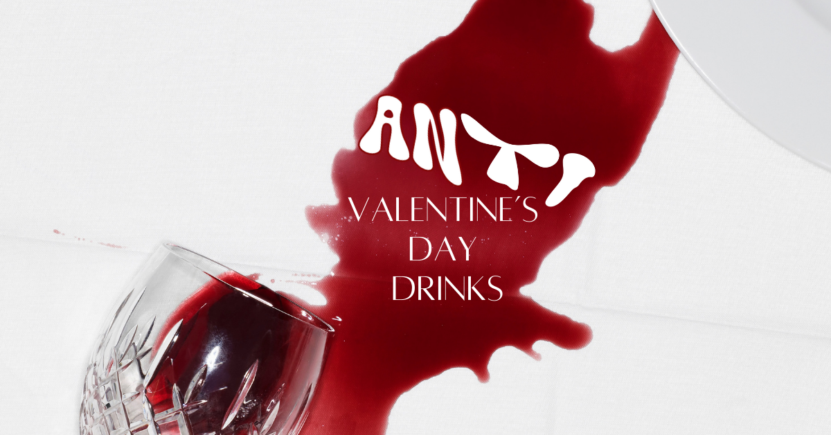 a glass of spilled red whine spills across a white surface and runs into a white plate that is partially visible in the top right corner. in the spill of the red wine the word anti flows with the spilled red wine. Below it, it continues Valentines Day Drinks