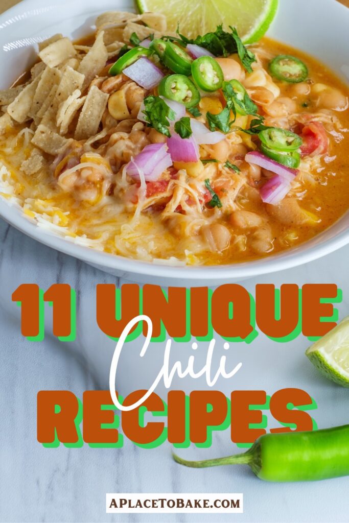 A bowl of chicken chili with a lime, sliced jalapeños, and tortillas strips sit on a marble table with a slice of lime and a jalapeño. Text that reads 11 Unique Chili recipes covers the marble surface but partially sits behind the bowl, lime, and jalapeño