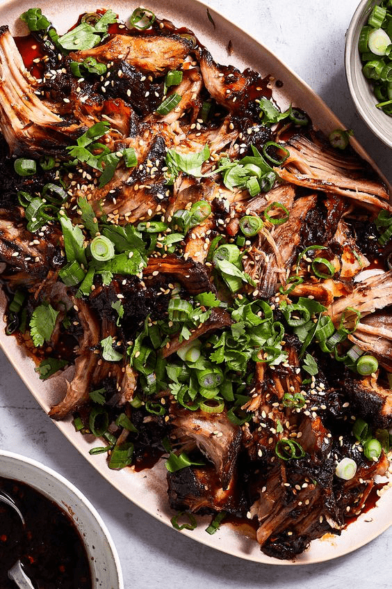 shredded honey soy pork topped with green onions 