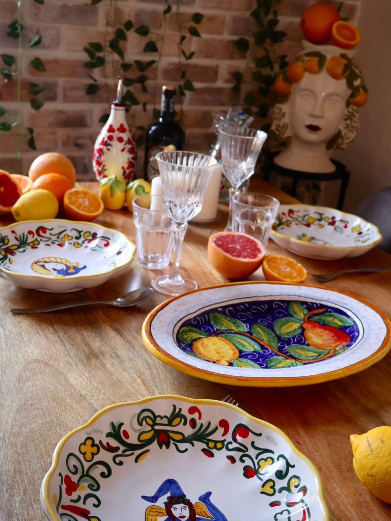 Italian table styled with colorful ceramics and fresh citrus
